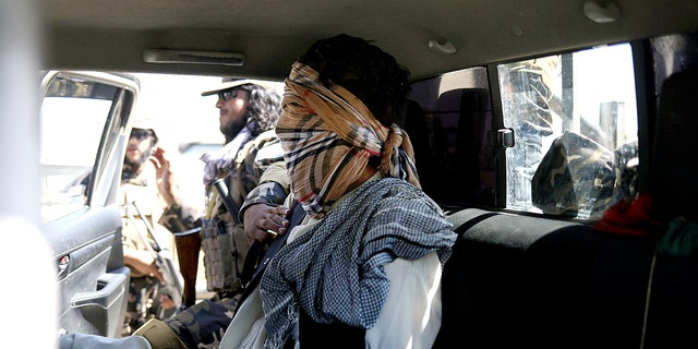 A suspected ISIS member siting blindfolded in a Taliban Special Forces' car in Kabul.