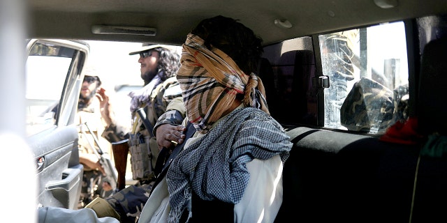 A suspected ISIS member siting blindfolded in a Taliban Special Forces' car in Kabul.