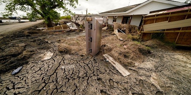 A casket that floated from its tombs during flooding from Hurricane Ida sits in a lawn of a destroyed home in Ironton, Louisiana, on Sept. 27.