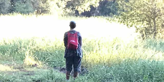 Roberta Laundrie stands in a clearing in the Myakkahatchee Creek Environmental Park on Oct. 20, 2021, just yards away from where police found her son's skeletal remains that morning.