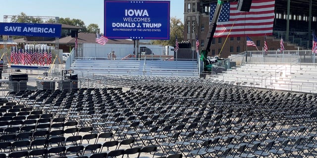 Workers at the site of former President Trump's Iowa rally put the finishing touches on the venue at the Iowa State Fairgrounds on the eve of the event, on Oct. 8, 2021 in Des Moines, Iowa
