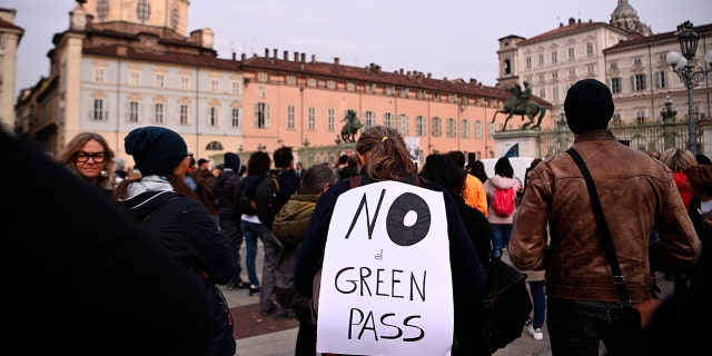 People gather and hold a No Green Pass protest in Turin, Italy on Friday.