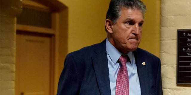 FILE PHOTO: U.S. Senator Joe Manchin (D-WV) walks through the U.S. Capitol in Washington, U.S., October 21, 2021. REUTERS/Elizabeth Frantz/File Photo