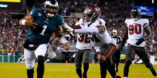 Philadelphia Eagles quarterback Jalan Hurts (1) runs the ball with pressure during the second half of the NFL football game against the Tampa Bay Buccaneers on Thursday, October 14, 2021 in Philadelphia.