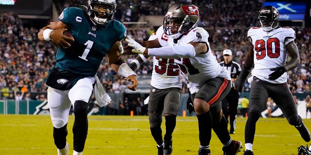 Philadelphia Eagles quarterback Jalen Hurts (1) runs with the ball under pressure during the second half of an NFL football game against the Tampa Bay Buccaneers on Thursday, Oct. 14, 2021, in Philadelphia.