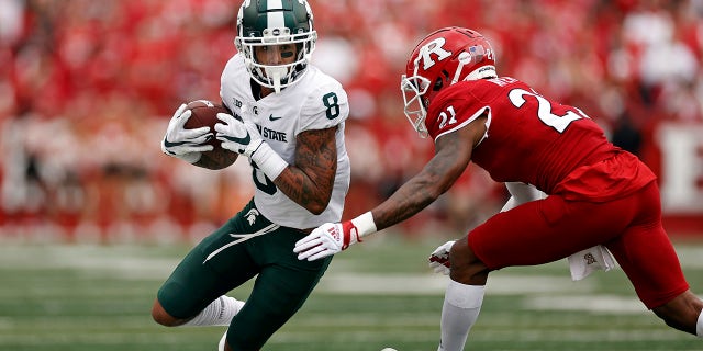 Michigan State wide receiver Jalen Nailor (8) is forced out of bounds by Rutgers defensive back Tre Avery during the first half of an NCAA college football game Saturday, Oct. 9, 2021, in Piscataway, N.J.