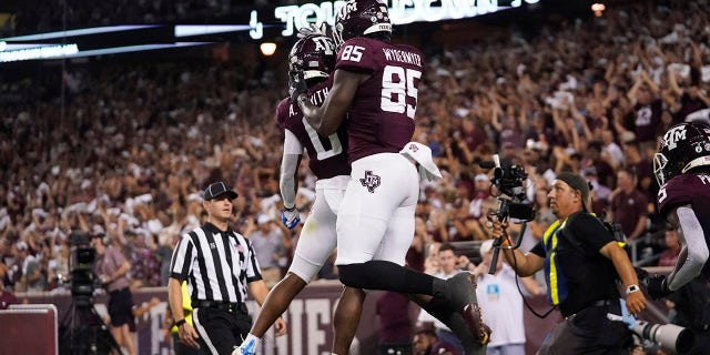 Texas A&M tight end Jalen Wydermyer (85) celebrates with wide receiver Ainias Smith (0) after scoring a touchdown agent Alabama during the first half of an NCAA college football game Saturday, Oct. 9, 2021, in College Station, Texas.