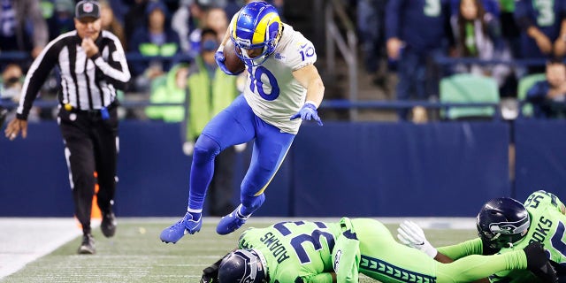 Los Angeles Rams wide receiver Cooper Kupp leaps over Seattle Seahawks safety Jamal Adams (33) Oct. 7, 2021, in Seattle. 