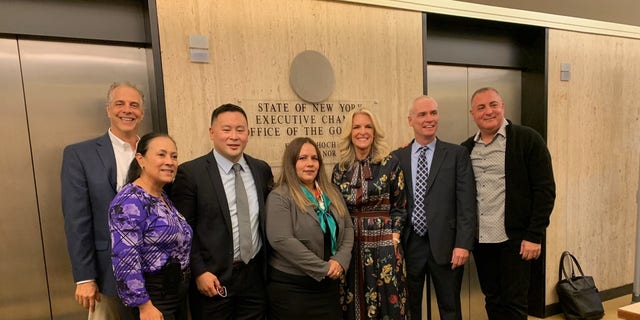  Daniel Arbeeny, Haydee Pabney, Assemblyman Ron Kim, Alexa Rivera Janice Dean, her husband Sean Newman and Peter Arbeeny pose for a photo before meeting with New York Gov. Hochul  about 2020 COVID nursing home deaths on October 12, 2021.
