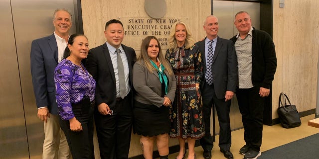 Daniel Arbeeny, Haydee Pabney, Assemblyman Ron Kim, Alexa Rivera Janice Dean, her husband Sean Newman and Peter Arbeeny pose for a photo before meeting with New York Gov. Hochul about 2020 COVID nursing home deaths on October 12, 2021.