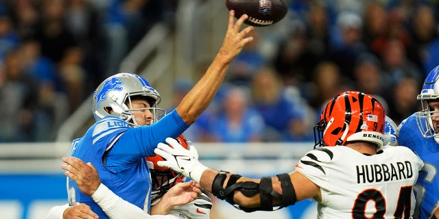Detroit Lions quarterback Jared Goff is pressured by Cincinnati Bengals defensive end Trey Hendrickson during the first half of an NFL football game, Sunday, Oct. 17, 2021, in Detroit.