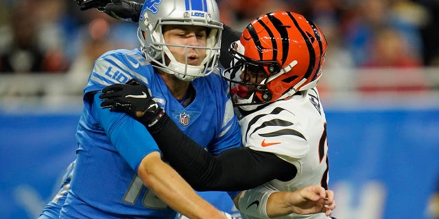 Detroit Lions quarterback Jared Goff (16) is pressured by Cincinnati Bengals safety Vonn Bell during the first half of an NFL football game, Sunday, Oct. 17, 2021, in Detroit.