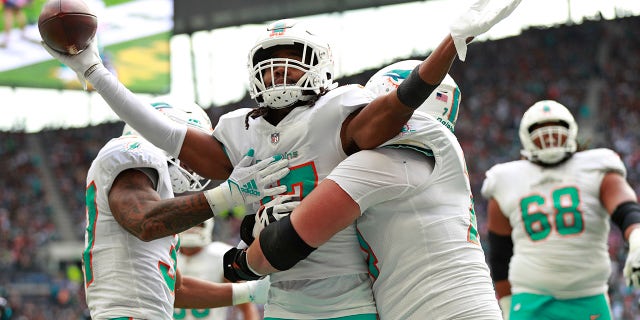 Miami Dolphins wide receiver Jaylen Waddle (17) celebrates after scoring a touchdown during the first half of an NFL football game between the Miami Dolphins and the Jacksonville Jaguars at the Tottenham Hotspur stadium in London, England, Sunday, Oct. 17, 2021.