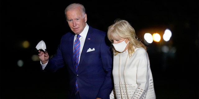President Joe Biden waves as he and first lady Jill Biden walk on the South Lawn of the White House after stepping off Marine One, Thursday, Oct. 21, 2021, in Washington. (AP Photo/Patrick Semansky)