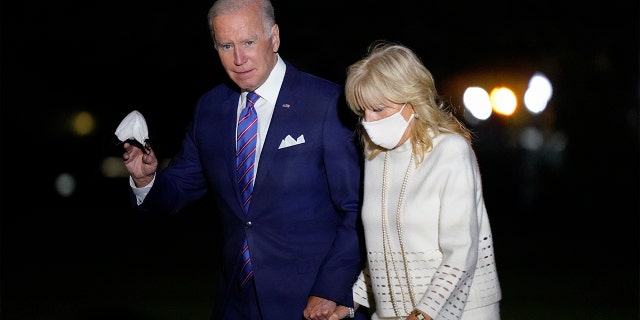 President Joe Biden waves as he and first lady Jill Biden walk on the South Lawn of the White House after stepping off Marine One, Thursday, Oct. 21, 2021, in Washington. (AP Photo/Patrick Semansky)