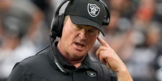 Las Vegas Raiders head coach Jon Gruden speaks on his headset during the first half of an NFL football game against the Chicago Bears, Sunday, Oct. 10, 2021, in Las Vegas.