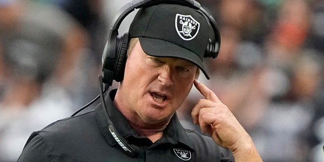Las Vegas Raiders head coach Jon Gruden speaks on his headset during the first half of an NFL football game against the Chicago Bears, Sunday, Oct. 10, 2021, in Las Vegas.