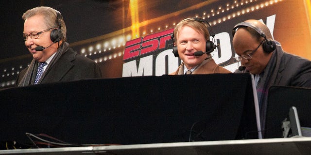 Members of the Monday Night announcing crew Ron Jaworski, John Gruden and Mike Tirico of ESPN look on during the game between the New England Patriots and the New York Jets at Gillette Stadium on December 06, 2010 in Foxboro, Massachusetts.