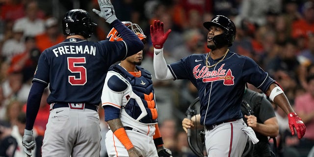 Atlanta Braves' Jorge Soler celebrates his home run with Freddie Freeman during the first inning of Game 1 in baseball's World Series between the Houston Astros and the Atlanta Braves Tuesday, Oct. 26, 2021, in Houston.