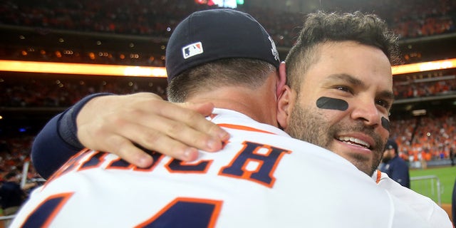 Jose Altuve #27 of the Houston Astros celebrates with manager A.J. Hinch #14 after defeating the New York Yankees by a score of 4-0 to win Game Seven of the American League Championship Series at Minute Maid Park on October 21, 2017, in Houston, Texas. 