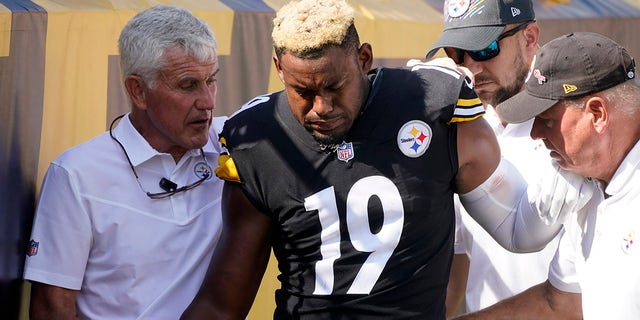 Pittsburgh Steelers wide receiver JuJu Smith-Schuster (19) is helped off the field after being injured during the first half of an NFL football game against the Denver Broncos in Pittsburgh, Sunday, Oct. 10, 2021.