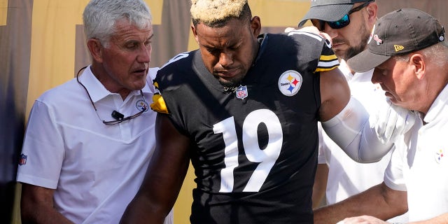 Pittsburgh Steelers wide receiver JuJu Smith-Schuster (19) is helped off the field after being injured during the first half of an NFL football game against the Denver Broncos in Pittsburgh, Sunday, Oct. 10, 2021.