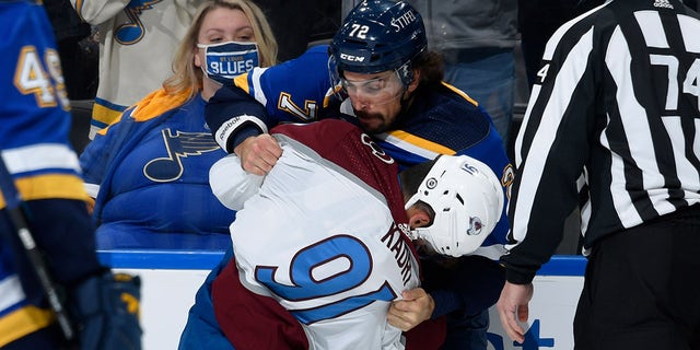 Justin Faulk of the St. Louis Blues and Nazem Kadri (91) of the Colorado Avalanche fight during the game at the Enterprise Center on Oct. 28, 2021, in St. Louis, Missouri.