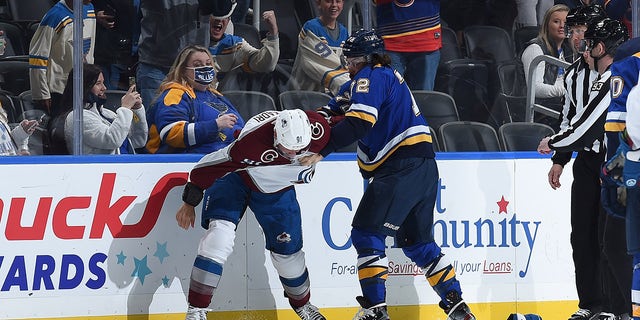 Justin Faulk (72) of the St. Louis Blues gets physical with Nazem Kadri of the Colorado Avalanche at the Enterprise Center on Oct. 28, 2021, in St. Louis, Missouri.