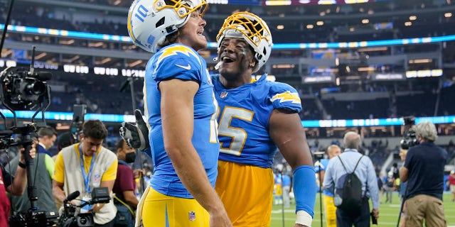Los Angeles Chargers quarterback Justin Herbert, left, and running back Larry Rountree III celebrate after the Chargers defeated the Las Vegas Raiders 28-14 in an NFL football game Monday, Oct. 4, 2021, in Inglewood, Calif.