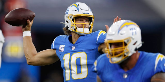 Quarterback Justin Herbert #10 of the Los Angeles Chargers passes against the Las Vegas Raiders during the first half at SoFi Stadium on October 4, 2021 in Inglewood, California.