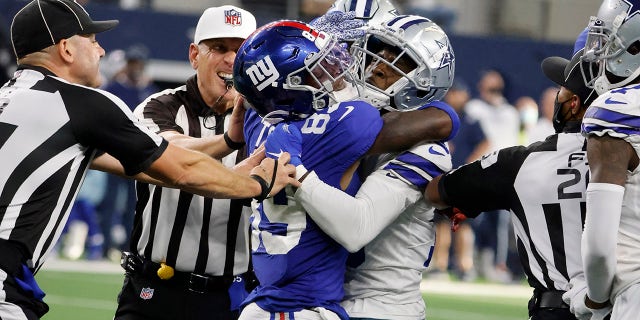 Officials attempt to separate New York Giants' Kadarius Toney (89) and Dallas Cowboys' Damontae Kazee, right, after Toney threw a punch at Kazee in the second half of an NFL football game in Arlington, Texas, Sunday, Oct. 10, 2021.