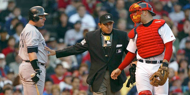 Karim Garcia (28) of the New York Yankees reacts to being hit by a pitch by Pedro Martinez (45) of the Boston Red Sox during Game 3 of the 2003 American League Championship Series Oct. 11, 2003, at Fenway Park in Boston, Massachusetts.