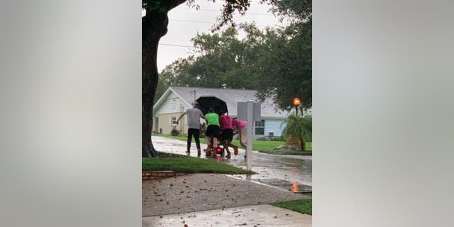 Katty Castro told Fox News that JohnMorgan Massa and his colleagues made a three-quarter-mile trek as they carefully pushed the resident while she remained on her scooter.