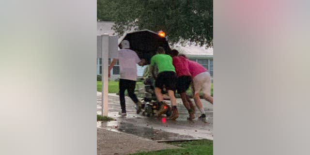 Katty Castro, a public relations representative at the Florida Living Independent Community in Seminole County, Florida, witnessed the rescue and snapped pictures of the group who valiantly pushed the resident’s scooter to her planned destination.