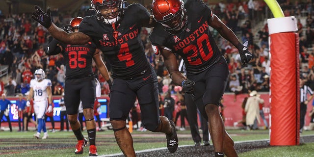 Oct 30, 2021; Houston, Texas, USA; Houston Cougars wide receiver KeSean Carter (20) celebrates with running back Ta'Zhawn Henry (4) after scoring a touchdown during the fourth quarter against the Southern Methodist Mustangs at TDECU Stadium.
