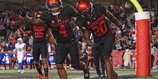 Oct 30, 2021; Houston, Texas, USA; Houston Cougars wide receiver KeSean Carter (20) celebrates with running back Ta'Zhawn Henry (4) after scoring a touchdown during the fourth quarter against the Southern Methodist Mustangs at TDECU Stadium.