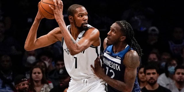 Minnesota Timberwolves' Taurean Prince, right, defends against Brooklyn Nets' Kevin Durant during the first half of a preseason NBA basketball game Thursday, Oct. 14, 2021, in New York.