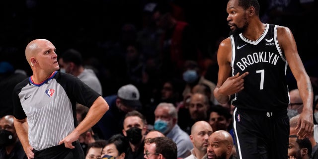 Brooklyn Nets forward Kevin Durant (7) argues with referee Jacyn Goble, left, during the second half of an NBA basketball game, Wednesday, Oct. 27, 2021, in New York.