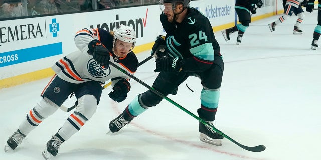 Edmonton Oilers' James Hamblin (57) skates past Seattle Kraken's Jamie Oleksiak (2) in the first period of a preseason NHL hockey game Friday, Oct. 1, 2021, in Everett, Wash.