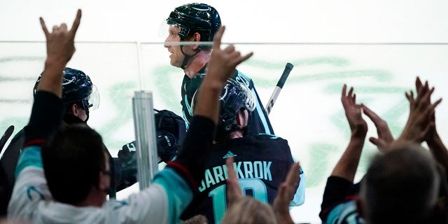 Seattle Kraken's Jaden Schwartz skates past cheering fans after scoring against the Edmonton Oilers in the third period of a preseason NHL hockey game Friday, Oct. 1, 2021, in Everett, Wash.