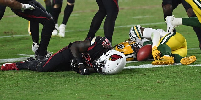 GLENDALE, ARIZONA - OCTOBER 28: Jonathan Ward #29 of the Arizona Cardinals and Kylin Hill #32 of the Green Bay Packers are injured on a play during the second half of a game at State Farm Stadium on October 28, 2021 in Glendale, Arizona.