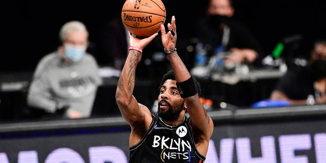 Kyrie Irving of the Brooklyn Nets attempts a jump shot against the Milwaukee Bucks in Game 2 of the second round of the 2021 NBA Playoffs at Barclays Center on June 7, 2021 in New York City.