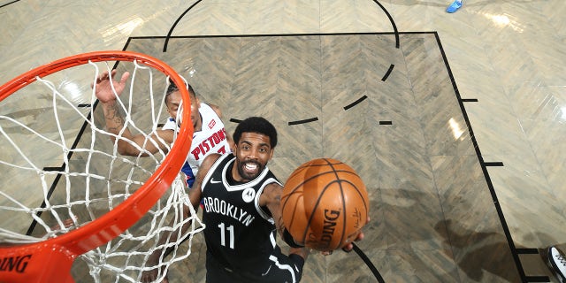 Kyrie Irving #11 of the Brooklyn Nets shoots the ball during the game against the Detroit Pistons on March 13, 2021 at Barclays Center in Brooklyn, New York.