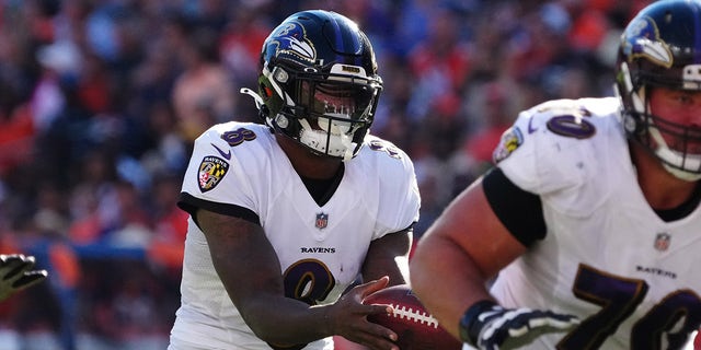 Oct 3, 2021; Denver, Colorado, USA; Baltimore Ravens quarterback Lamar Jackson (8) takes a hike in the second quarter against the Denver Broncos at Empower Field at Mile High.