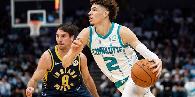 Charlotte Hornets guard LaMelo Ball (2) drives to the basket while guarded by Indiana Pacers guard T.J. McConnell (9) in Charlotte, N.C., Okt.. 20, 2021.
