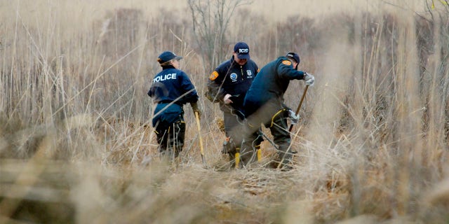Crime Scene investigators using metal detectors to search a marsh for the remains of Shannan Gilbert on Dec. 12, 2011, in Oak Beach, New York.