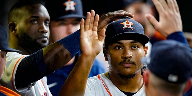 Houston Astros starting pitcher Luis Garcia is greeted in the dugout after leaving the game during the sixth inning in Game 6 of baseball's American League Championship Series against the Boston Red Sox Friday, Oct. 22, 2021, in Houston.