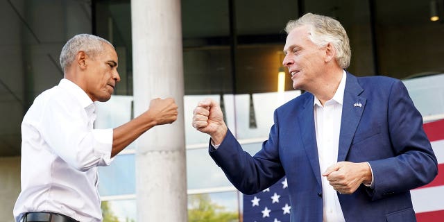 Virginia Democratic gubernatorial candidate Terry McAuliffe fist bumps former President Obama during his campaign rally in Richmond, Virginia, Oct. 23, 2021.