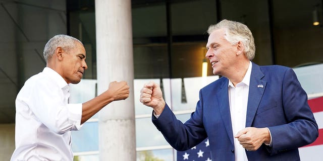 Virginia Democratic gubernatorial candidate Terry McAuliffe fist bumps former U.S. President Barack Obama during his campaign rally in Richmond, Virginia, U.S. October 23, 2021. REUTERS/Kevin Lamarque