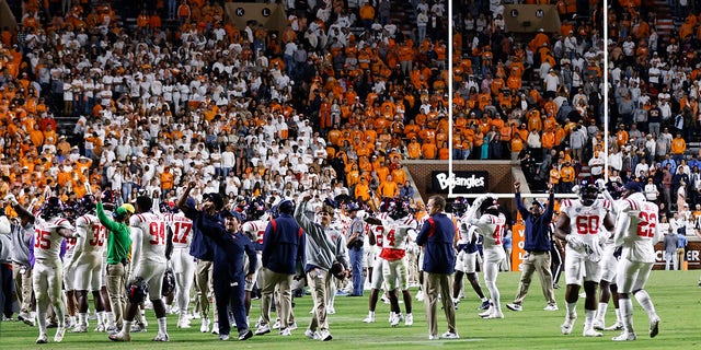 Mississippi players stand on the field after the game was delayed because of fans throwing bottles onto the field during the second half of the team's NCAA college football game against Tennessee, Saturday, Oct. 16, 2021, in Knoxville. Mississippi won 31-26.